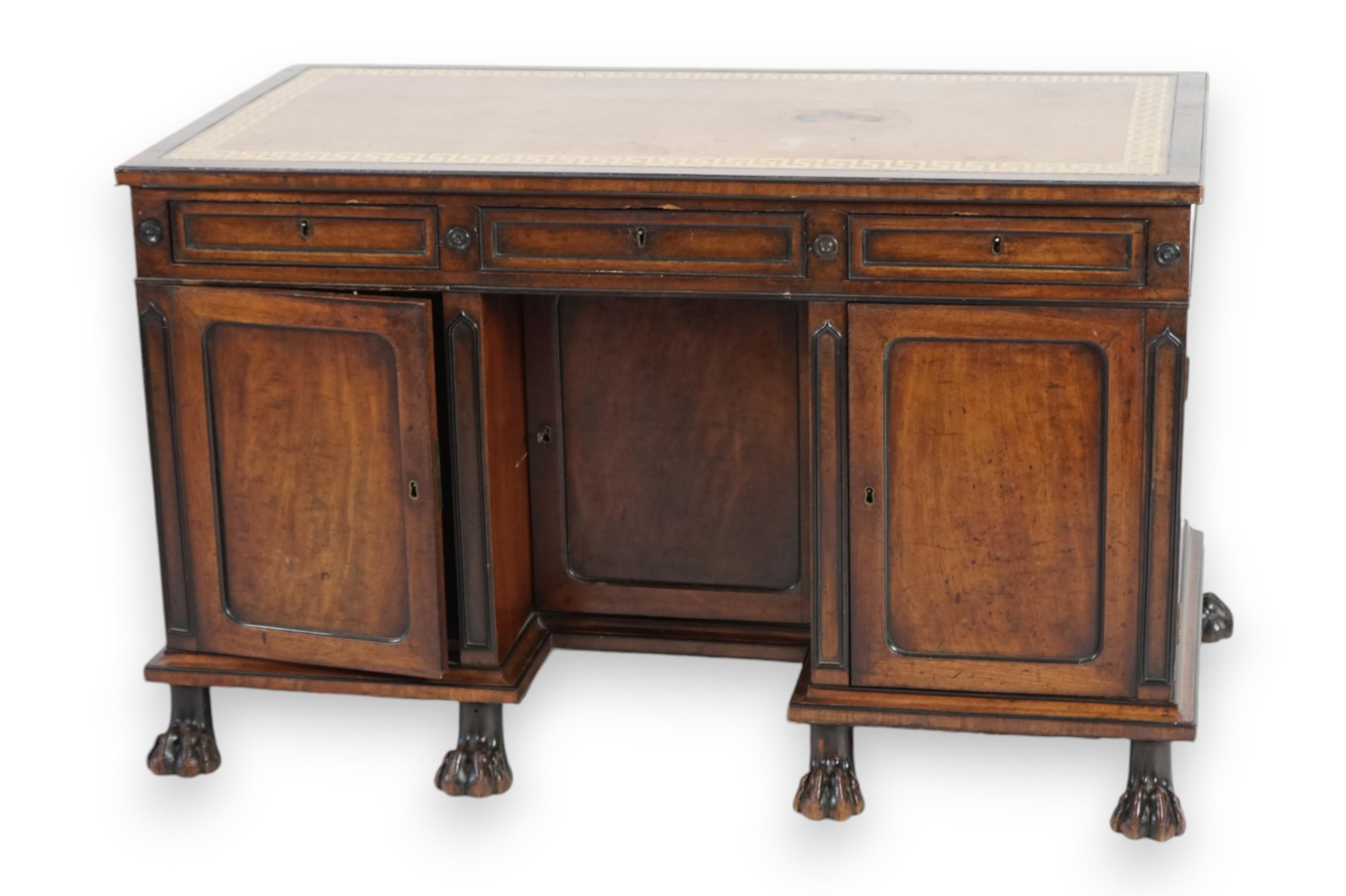 A Regency ebony strung mahogany kneehole desk